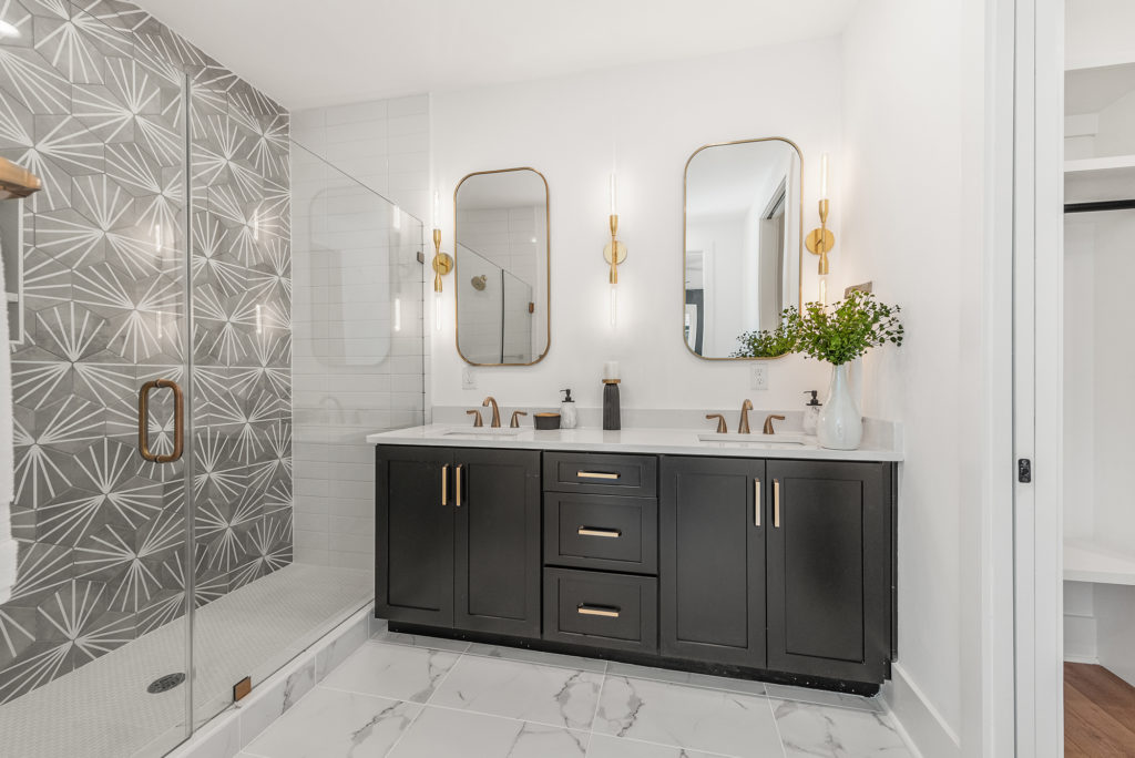 master bathroom with gray hex tile and a double vanity with uttermost mirrors