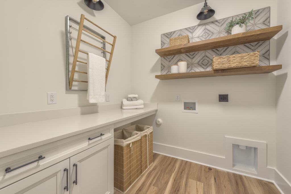 laundry room organization with Pottery Barn drying rack and Floor and Decor Wall tile