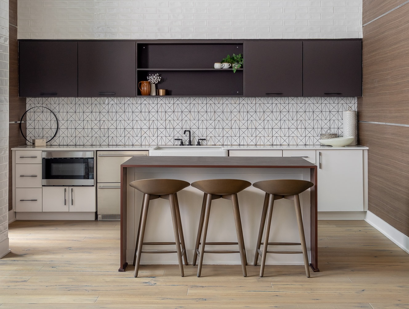 bold interior design trends include dark wood cabinetry with a modern geometric tile backsplash