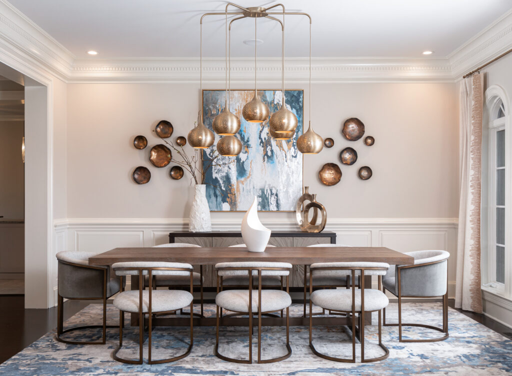 bold interior design with a gold modern pendant and teal artwork by Gracious Home Interiors 